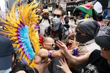 A pride marcher clashes with pro-Palestinian protesters.