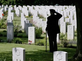Second World War and D-Day veteran Roy Shaw, from Barrie, Ont., salutes his fallen comrades at the Canadian war cemetery Beny-sur-Mer, five kilometres from Juno Beach, in Reviers, France on Friday, June 6, 2003 in this photo by Canadian Press photographer Tom Hanson.
