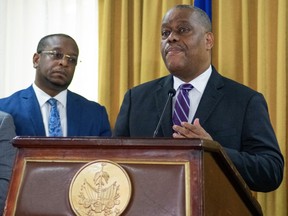 Garry Conille, right, speaks after being installed as Haiti's interim Prime Minister in Port-au-Prince, Monday, June 3, 2024.