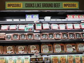 Packages of "Impossible Foods" burgers and Beyond Meat made from plant-based substitutes for meat products sit on a shelf for sale on November 15, 2019 in New York City.