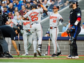 Anthony Santander of the Baltimore Orioles is welcomed to the plate by Ryan O'Hearn as they celebrate a two-run home run in the second inning against the Blue Jays at Rogers Centre on June 3, 2024 in Toronto.