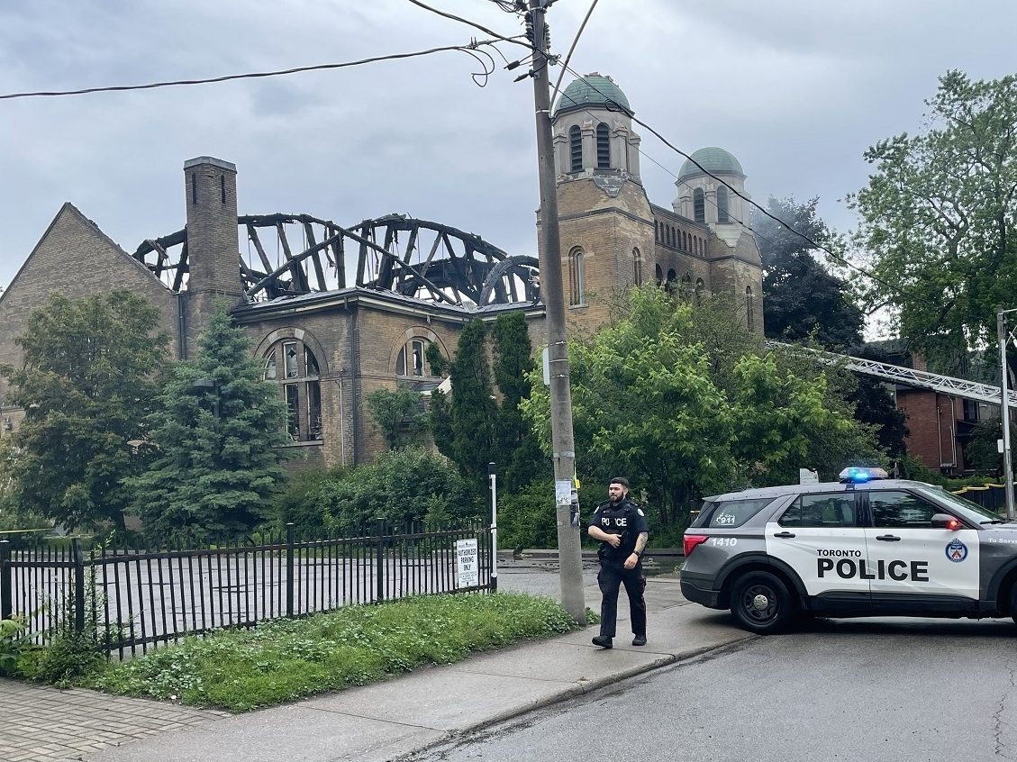  A police officer patrols the scene of a fire at St. Anne’s Anglican Church in Toronto on Sunday, June 9, 2024.