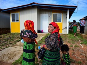 Indigenous Gunas wait outside their new homes in Nuevo Carti, Guna Yala Comarca, on the Caribbean coast in mainland Panama, on May 29, 2024.