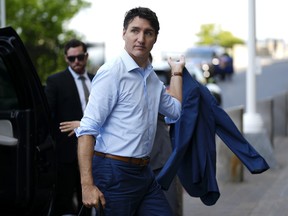 Justin Trudeau steps out of a vehicle