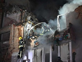 Rescuers extinguish a fire in an apartment building destroyed by a Russian missile attack in Kharkiv early on May 31, 2024, amid the Russian invasion in Ukraine.