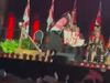 A screen grab from a video circulating on social media. It appears to show a McGill University student making a spitting motion at university officials before unfurling a banner reading: "Divest from death."