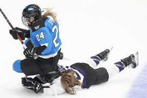 PWHL Toronto star Natalie Spooner, left, gets tripped up in a game.