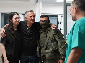 This handout picture released by the Israeli Army on June 8, 2024, shows Noa Argamani (left), 26, standing next to a relative (second from left) at the Sheba Tel-HaShomer Medical Centre, after her rescue from the Gaza Strip by the Israeli army, in Ramat Gan near Tel Aviv on June 8, 2024, amid the ongoing conflict in the Palestinian territory between Israel and the militant group Hamas.