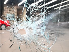 One of the bullet holes left in a window after someone fired shots on Sept. 4, 2023 at a car dealership run by Marco Pizzi, an alleged member of the Montreal Mafia. The photo was presented as evidence during the bail hearing of Mathieu Scott-Dumont.