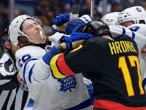 Tyler Bertuzzi of the Leafs is shoved by Canucks blueliner Filip Hronek in a January game.