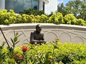 A statue of Walt Disney, known as “Walt the Dreamer”, sits on a bench in one of the World Celebration Gardens at Epcot. The World Celebration Gardens are one of many new additions at Epcot. (EDDIE CHAU/Toronto Sun)