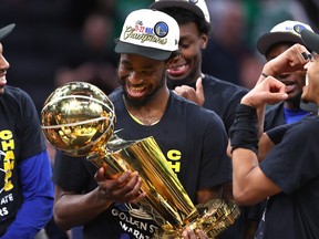 Canadian Andrew Wiggins of the Golden State Warriors celebrates with th Larry O'Brien Championship Trophy after defeating the Boston Celtics in Game 6 of the 2022 NBA Finals at TD Garden on June 16, 2022 in Boston.