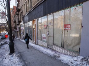 A pedestrian walks past an empty store front in Montreal, Wednesday, Jan. 29, 2020.