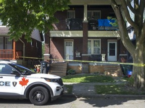Yellow police tape surrounds a duplex in the 500 block of McEwan Avenue on May 19, 2021, where Windsor police were investigating a serious incident from the night before that led to a man's death and two others charged with murder.