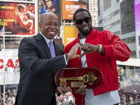 Mayor Eric Adams, left, presenting the Key to the City to hip-hop artist Sean "Diddy" Combs