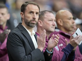 England's head coach Gareth Southgate applauds before the start of the International friendly soccer match between England and Iceland at Wembley stadium in London, Friday, June 7, 2024.