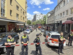 Police cordon off an area near the Reeperbahn in Hamburg, Germany, Sunday, June 16, 2024. German police say officers have shot and wounded a man who was threatening them with an axe and a firebomb in the northern city of Hamburg, hours before the city hosts a match in the Euro 2024 soccer tournament.