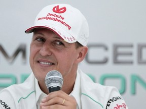 FILE - Michael Schumacher announces his retirement from Formula One during a press conference at the Suzuka Circuit venue for the Japanese Formula One Grand Prix in Suzuka, Japan, Oct. 4, 2012. German prosecutors say two men who allegedly tried blackmailing the family of former Formula 1 champion Michael Schumacher were detained earlier this month. Prosecutors in the western German city of Wuppertal said Monday the suspects told employees of the family that they were in possession of files that the family would not want to be published.