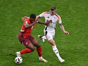 Switzerland's forward Kwadwo Duah, left, and Germany's midfielder Toni Kroos vie for the ball during the UEFA Euro 2024 Group A football match between Switzerland and Germany at the Frankfurt Arena in Frankfurt am Main on June 23, 2024.