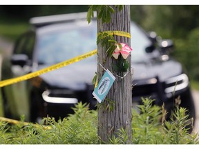 Flowers and a card are shown in front of a home in the 1200 block of County Road 13 in Harrow on Friday, June 21, 2024. Four people were found dead on the property on Thursday.
