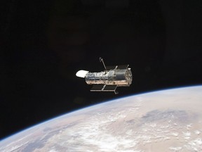 This photo provided by NASA, an STS-125 crew member aboard the Space Shuttle Atlantis captured this image of NASA's Hubble Space Telescope on May 19, 2009.