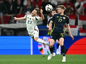 Hungary's forward Kevin Csoboth, left, fights for the ball with Scotland's midfielder Stuart Armstrong during the UEFA Euro 2024 Group A football match between Scotland and Hungary at the Stuttgart Arena in Stuttgart on June 23, 2024.