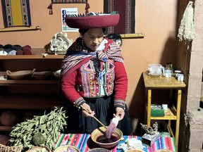 One of the ladies at Textil Cusi in Chinchero, Peru wears traditional clothing while demonstrating how the alpaca wool is dyed. CYNTHIA MCLEOD/TORONTO SUN