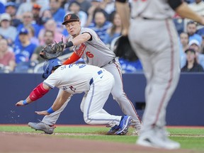 Baltimore Orioles' Ryan Mountcastle tags out BLue Jays' Davis Schneider at first base on a ground ball to third in the first inning at the Rogers Centre on June 4, 2024 in Toronto.