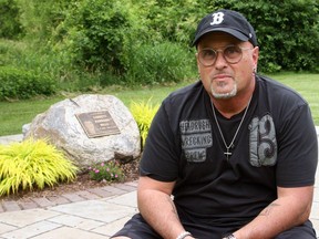 Dave Mills sits on a bench at the Garrett Mills Memorial at the park on King Street in Napanee. Garrett Mills was killed at the park in 2017 when an unanchored soccer net fell on top of him.