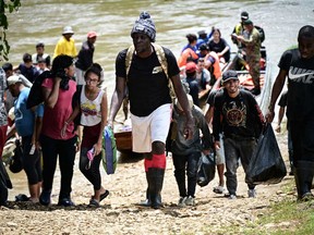 Migrants arrive at the Reception Center for Migrant Care in Lajas Blancas, in the jungle province of Darien, Panama, on June 28, 2024.