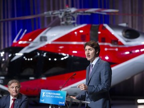 Prime Minister Justin Trudeau makes an aerospace economic announcement as President and Chief Executive Officer of CAE Inc. Marc Parent looks on, in Montreal, Thursday, July 15, 2021.