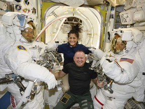 In this photo provided by NASA, Boeing Crew Flight Test astronauts Suni Williams and Butch Wilmore, centre, pose with Expedition 71 Flight Engineers Mike Barratt, left, and Tracy Dyson, both NASA astronauts, in their spacesuits aboard the International Space Station's Quest airlock on June 24, 2024.