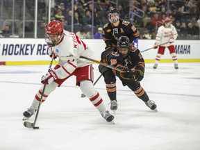 Boston University's Macklin Celebrini (71) skates with the puck in front of Rochester's Elijah Gonsalves (16) during an NCAA men's college hockey tournament regional game March 28, 2024, in Sioux Falls, S.D.