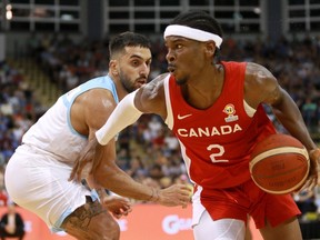 Basketball Canada has announced the Olympic training camp roster for the men's national team competing in the upcoming Paris Games. Canada's Shai Gilgeous-Alexander moves around Argentina's Facundo Campazzo during 2nd half action of the FIBA Basketball World Cup 2023 Americas Qualifiers in Victoria, Thursday, Aug. 25, 2022.