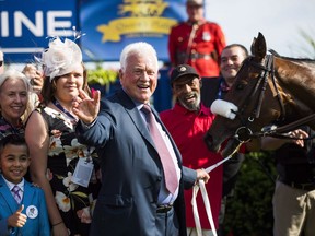 Frank Stronach poses with horse "Holy Helena" of Stronach Stables, after winning the 158th running of the Queen's Plate horse race at Woodbine Race Track, in Toronto, July 2, 2017. A court document shows 91-year-old billionaire businessman Stronach stands accused of sexually assaulting seven additional complainants from 1977 to as recently as February.
