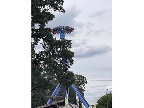 In this photo provided by Tieanna Joseph Cade, an amusement park ride is shown stuck with 30 people trapped upside down in Portland, Ore., on Friday, June 14, 2024. Portland Fire and Rescue said Friday on the social media site X that firefighters worked with engineers at Oaks Park to manually lower the ride. All riders were being evacuated and medically evaluated, it said.