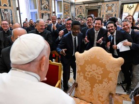 This photo taken and handout on June 14, 2024 by The Vatican Media shows U.S. actors Chris Rock (centre), Jimmy Fallon (centre right) and Pope Francis during an audience with comedians in the Vatican.