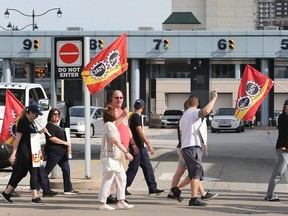 Members of the Public Service Alliance of Canada and the Customs and Immigration Union who work at Canada Border Services and supporters participate in a rally head of bargaining at the Detroit-Windsor tunnel in Windsor on Monday, May 13, 2024.