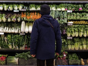 A customer shops in the produce section at a Metro grocery store In Toronto on Friday, Feb. 2, 2024.
