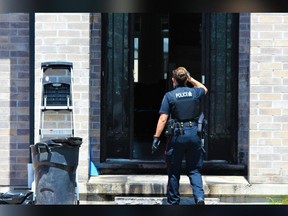 A London police officer enters a home on Wateroak Drive on Sunday June 9, 2024. Investigators ruled a fire at the house one night prior to be an arson and were treating it as a possible hate-motivated crime. Dale Carruthers / The London Free Press
