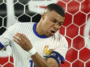France's forward #10 Kylian Mbappe reacts after being injured during the UEFA Euro 2024 Group D football match between Austria and France at the Duesseldorf Arena in Duesseldorf on June 17, 2024.