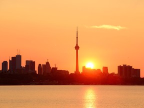 Toronto sunrise silhouetted over lake