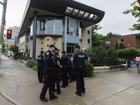 Toronto Police officers stand outside on the street near a press conference called by Canadian Jewish organizations in Toronto, June 3, 2024.
