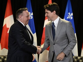 Prime Minister Justin Trudeau, right, and Quebec Premier Francois Legault shake hands as they meet, in Quebec City, Monday, June 10, 2024.
