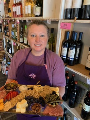Petals Wine Bar owner Theresa Campbell dishing up another charcuterie platter.