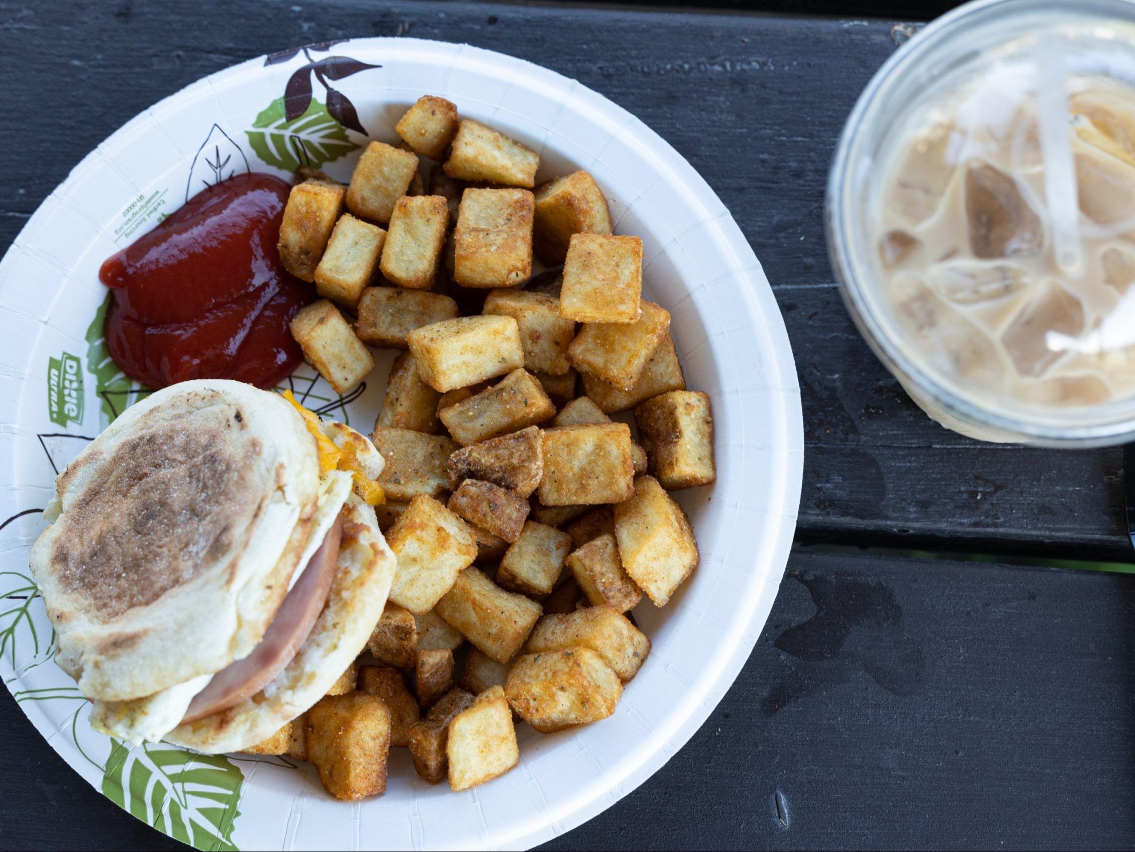 A breakfast sandwich and hashbrowns.