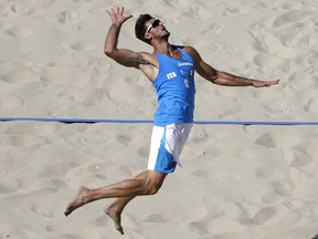 Italy's Alex Ranghieri prepares to spike during a men's beach volleyball match at the 2016 Summer Olympics.