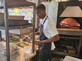 Chef Reggie Dotson prepares food at Ash'Kara
