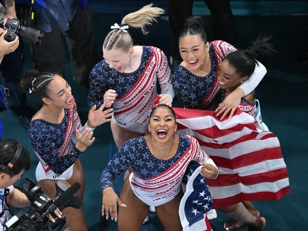 Simone Biles (right), Sunisa Lee (L), Jordan Chiles (front, Jade Carey (back) and Hezly Rivera celebrate after winning the artistic gymnastics women's team final.