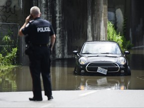 Emergency services respond to submerged vehicles at an underpass.